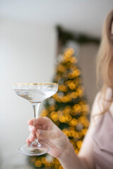 Photo of a glass for women on the background of a Christmas tree.