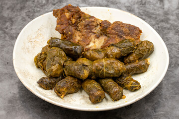 Meat leaf wrapping. Traditional Mediterranean flavor. Wrapping leaves on a dark background. local name etli yaprak sarma