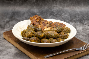 Meat leaf wrapping. Traditional Mediterranean flavor. Wrapping leaves on a dark background. local name etli yaprak sarma