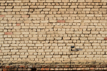 Fototapeta na wymiar Old brick wall with surveillance camera. Background for copy space.