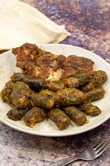 Meat leaf wrapping. Traditional Mediterranean flavor. Wrapping leaves on a dark background. local name etli yaprak sarma