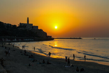 sunset by the sea in old jaffa district, tel aviv - obrazy, fototapety, plakaty
