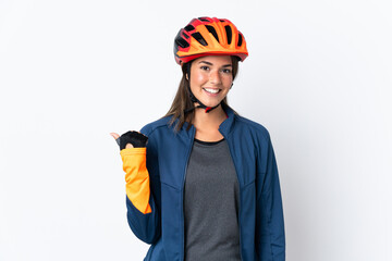 Young cyclist brazilian girl isolated on white  background pointing to the side to present a product