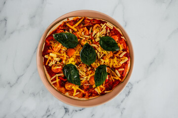 vegan margherita pizza with cherry tomatos and basil leaves topping, healthy plant-based food