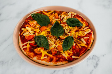 vegan margherita pizza with cherry tomatos and basil leaves topping, healthy plant-based food