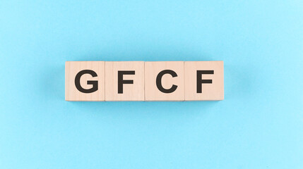 Wooden cube block with text GFCF on the blue background