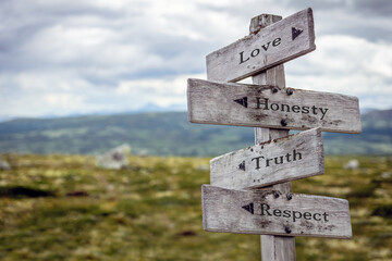love honesty truth respect text quote engraved on wooden weather washed sign outdoors in nature.