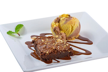 Chocolate brownie with ice cream on white plate. Dessert.