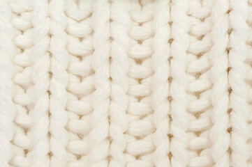 White knitted background.Texture with pigtails.