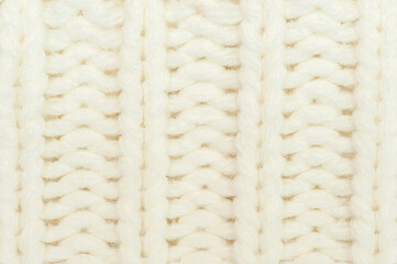 White knitted background.Repetitive machine Knitting sweater texture.