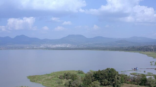 Aerial: lake, clouds and mountains. Drone view