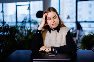 Young beautiful woman businesswoman suffers a headache from overwork. migraine at work