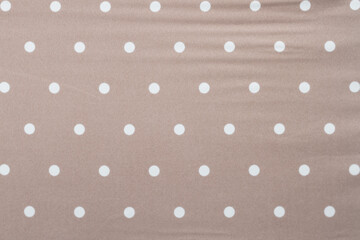 Beige fabric with white circles, background. Copy Space