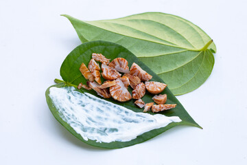Chewing betel nut, Betel nut with cal lime powder on betel leaves