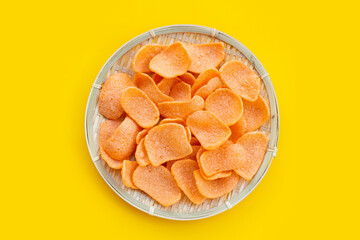 Prawn crackers on yellow background. Shrimp crispy rice snack