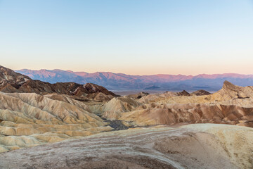 Fototapeta na wymiar Scenery while sunrise in the Death Valley with rocks and desert in the west of the U.S.