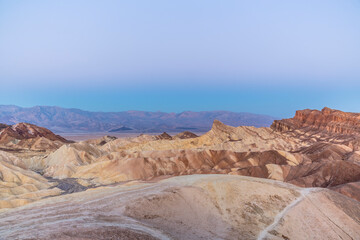 Scenery while sunrise in the Death Valley with rocks and desert in the west of the U.S.