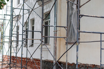 Scaffolding on the wall of a house in the city
