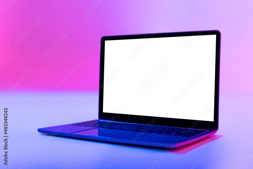 Aufkleber modern laptop pc with empty white screen in neon light, space for website or desktop. mockup