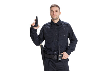 Half-length portrait of young male policeman officer wearing black uniform posing with gun isolated...