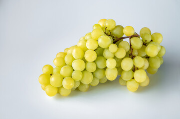 bunch of ripe green grapes on isolated white background