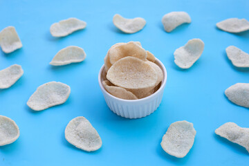 Prawn crackers on blue background. Shrimp crispy rice snack