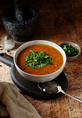 National Georgian dish kharcho soup in a bowl. Brown wooden background, vertical orientation, side view.
