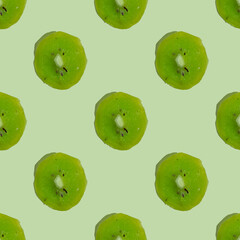 Seamless pattern with dried kiwi fruit on green background.
