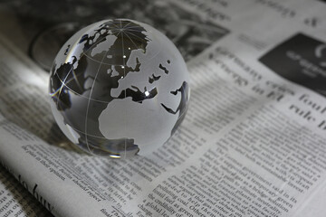 ガラスの地球儀と新聞　グローバルな事象のイメージ　glass globe(Europe and Africa) on  newspapers