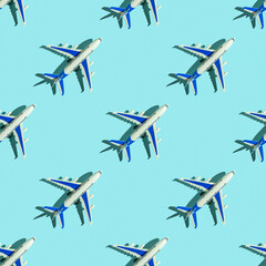 Seamless pattern with decorative passenger plane on blue background.