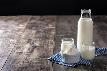 Milk kefir drink on wooden table. Liquid and fermented milk product on wooden table. Copy space