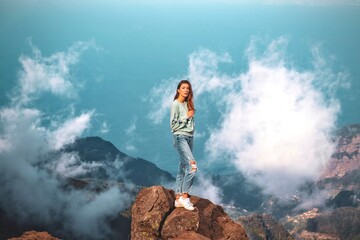 woman over the mountains from madeira pico do arieiro portugal 