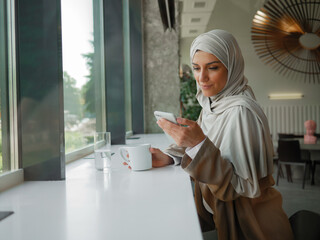 Muslim woman on remote working, online education or video conversation in caffe