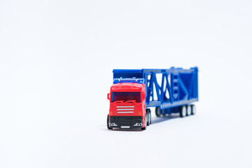 Toy car transporter with cars on a white background with place for text, copy space, for a toy store.