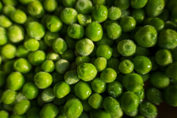 frozen frosty green peas background closeup
