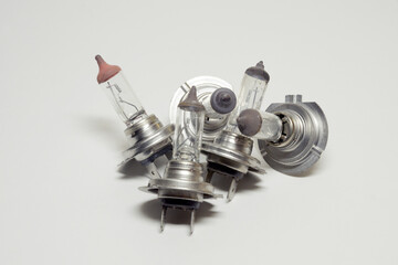 heap of used halogen lamps for automotive headlights, dual-contact connecting terminal