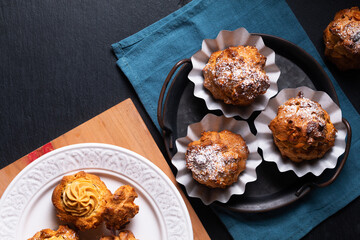 Food concept Homemade Caramel Choux a la cream or Choux cream puffs on dark background with copy space