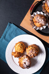Food concept Homemade Caramel Choux a la cream or Choux cream puffs on dark background with copy space