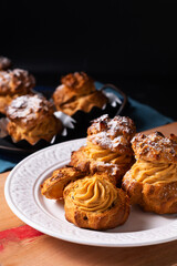 Food concept Homemade Caramel Choux a la cream or Choux cream puffs on dark background with copy space