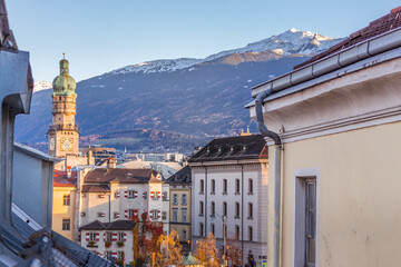Innsbruck, Austria - 11.21.2021: Aerial landmark of winter Innsbruck. Panorama of old town and mountains on background, Innsbruck. Picturesque landscape of Austrian Alps and town hall of Innsbruck.