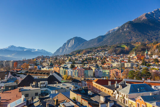 Innsbruck, Austria - 11.21.2021: Aerial landmark ща Innsbruck. Panorama of old town and mountains on background, Innsbruck. Picturesque landscape of Austrian Alps.