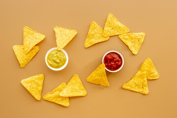 Tortilla nachos chips with red tomato salsa and avocado guacamole