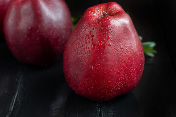Red apples on a dark, wooden background. Selective focus. Harvesting. Healthy food.