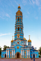 Cathedral of Our Lady's Nativity in summer sunny evening at sunset. Blue stone cathedral church with bell tower against sky. Monument of russian architecture, popular landmark. Ufa, Bashkiria, Russia