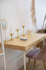 a table with white candles in a golden candlestick