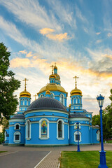 Fototapeta na wymiar Cathedral of Our Lady's Nativity in summer sunny evening at sunset. Blue stone cathedral church with golden domes against sky. Monument of russian architecture, popular landmark. Ufa,Bashkiria, Russia