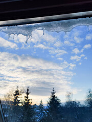 Taking photo of ice in a beautiful day full of snow. Looking out of the window during the winter.