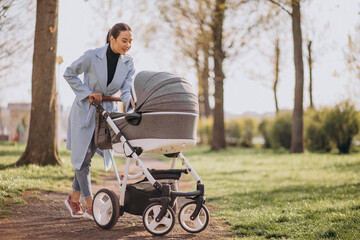 Young asian woman mother, walking with baby stroller in park