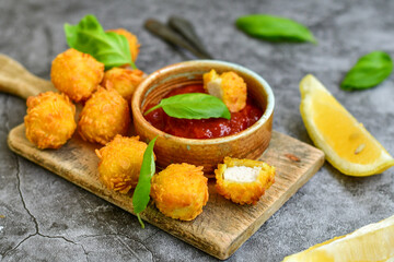 Crispy  deep fried   chicken  popcorn  nuggets . Breaded  with Cornflakes chicken  Breast fillets  with chilly peppers and fresh   basil on wooden rustic background