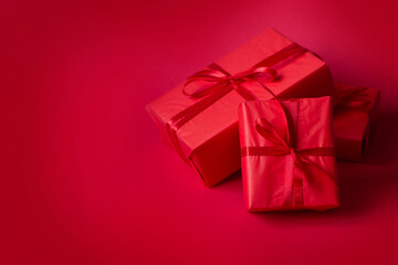 Red Valentine's Day background. Red gift boxes with red ribbon, empty space for text. Background for sales, advertising, greeting cards